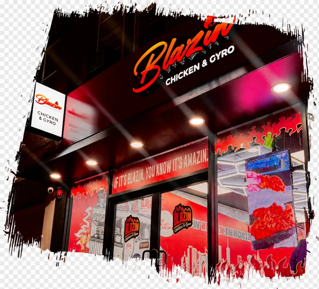Exterior of Blazin Chicken and Gyro in North Bergen with illuminated red signage, flame graphics, and front entrance at night.