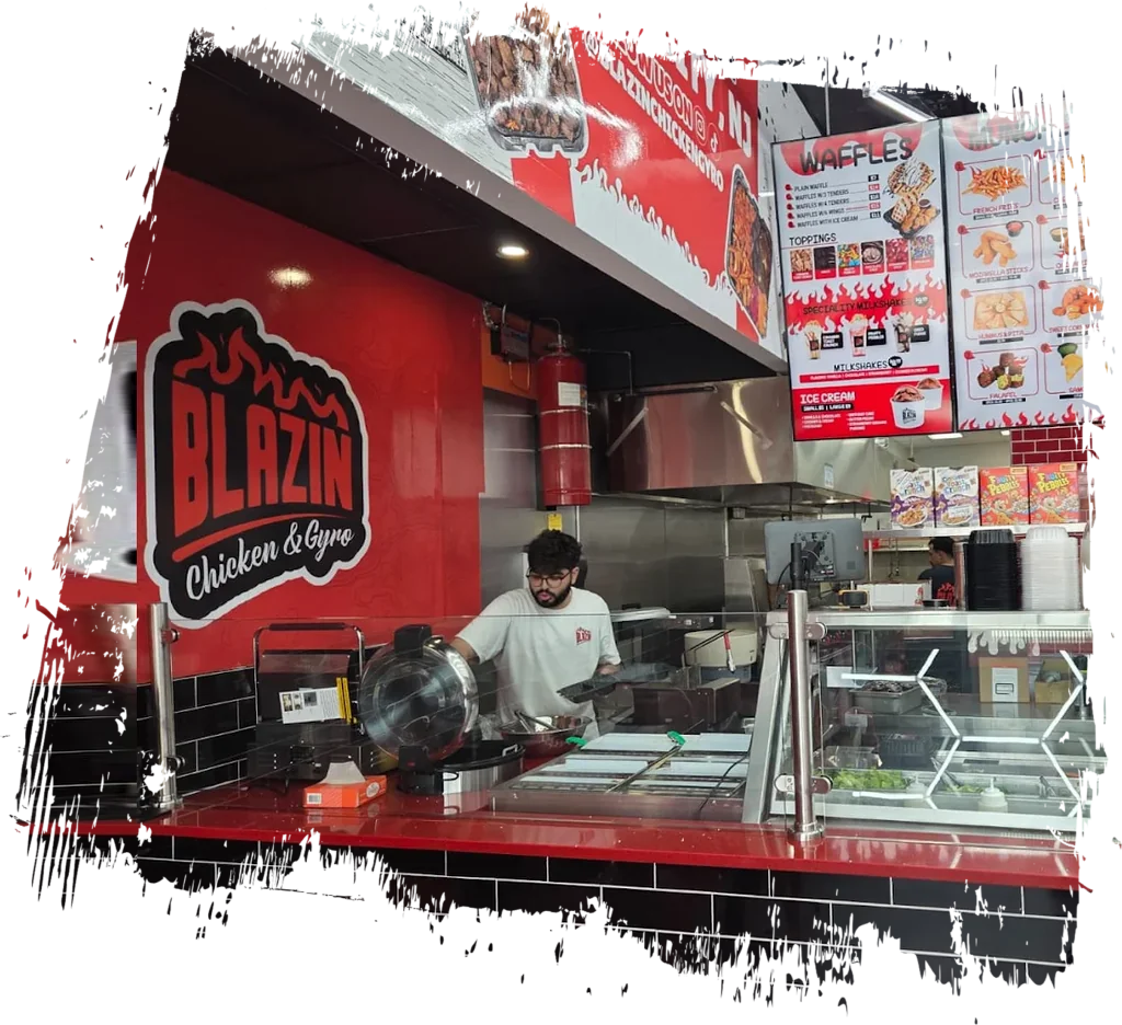 Inside Blazin Chicken and Gyro in Jersey City NJ, staff preparing fresh halal food behind the counter under the menu boards